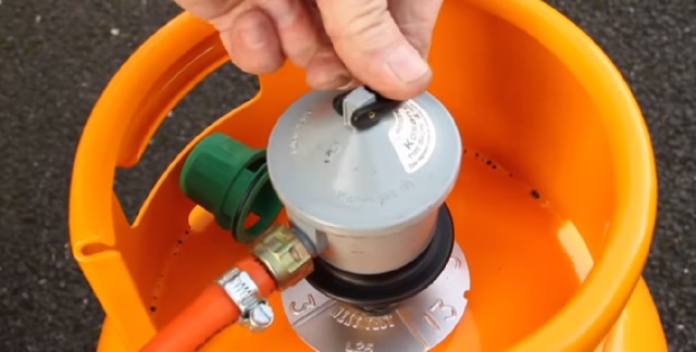 The regulator lever on top of the cylinder