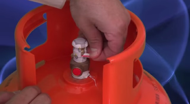 Removing the safety seal from the new cylinder